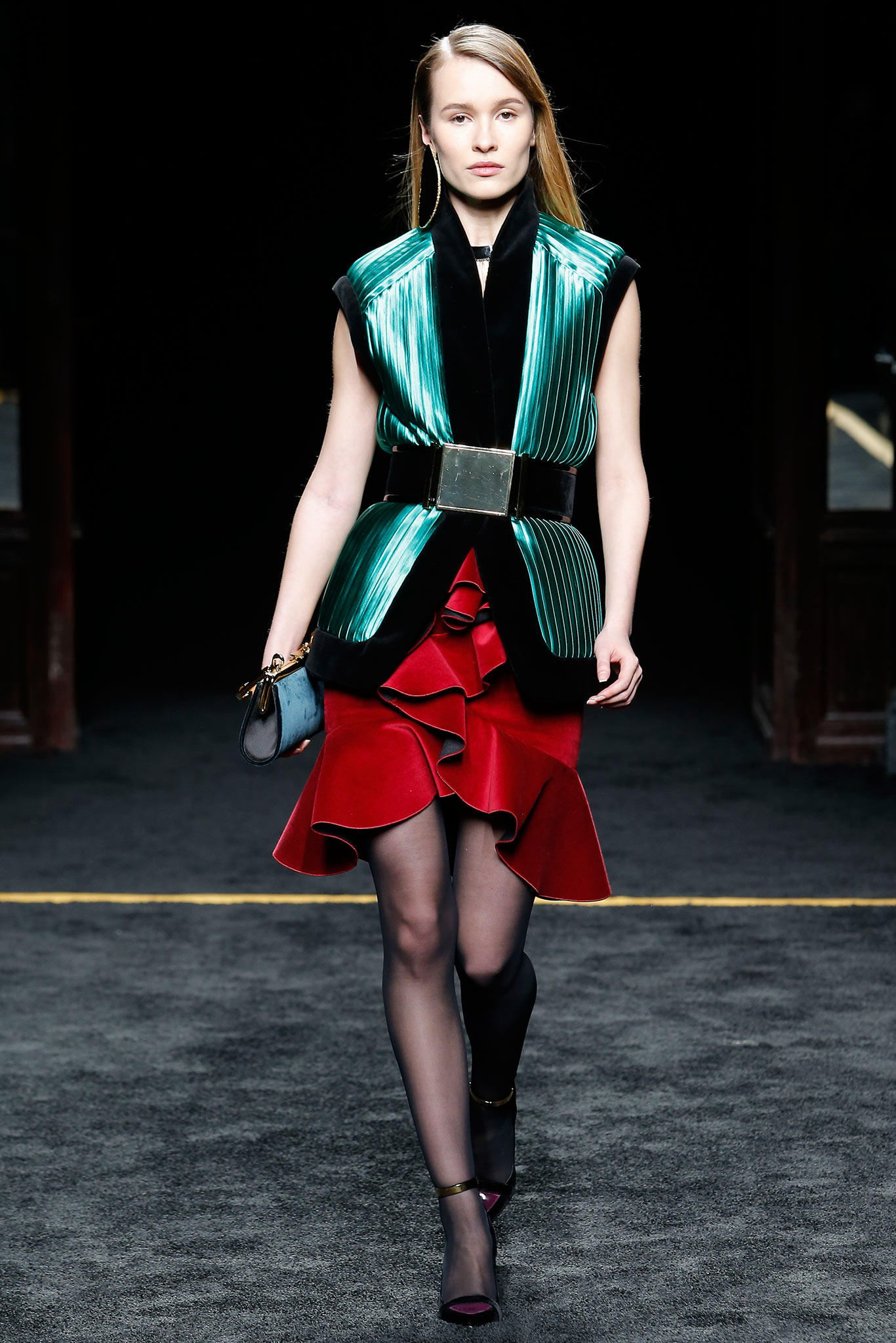 green silk sleeveless blazer and red ruffled skirt