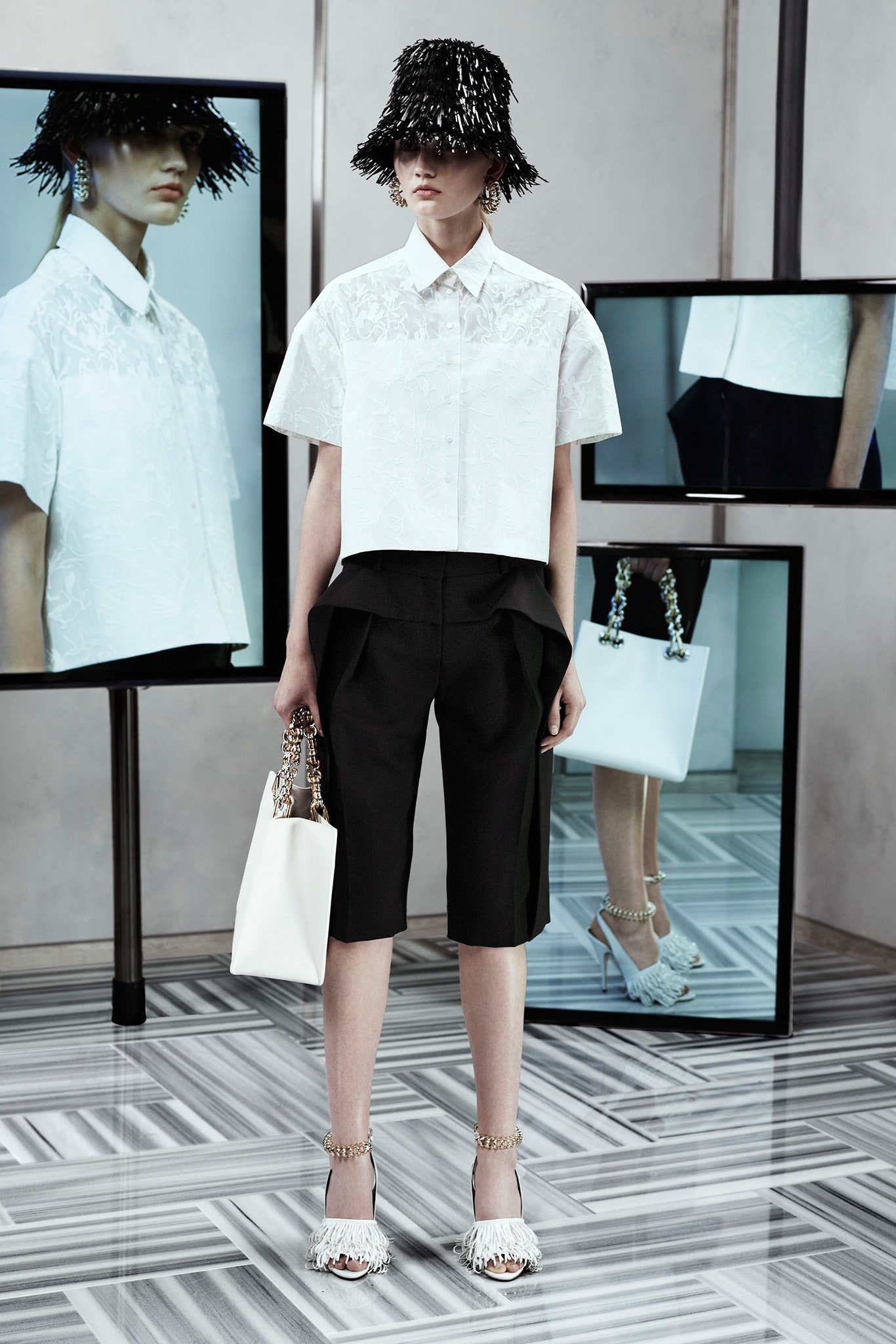 white embroidered top and black shorts
