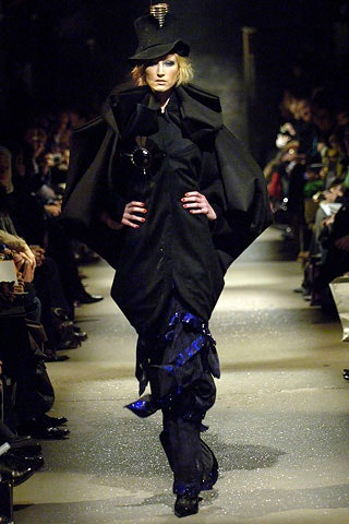 black structured cape with blue pants