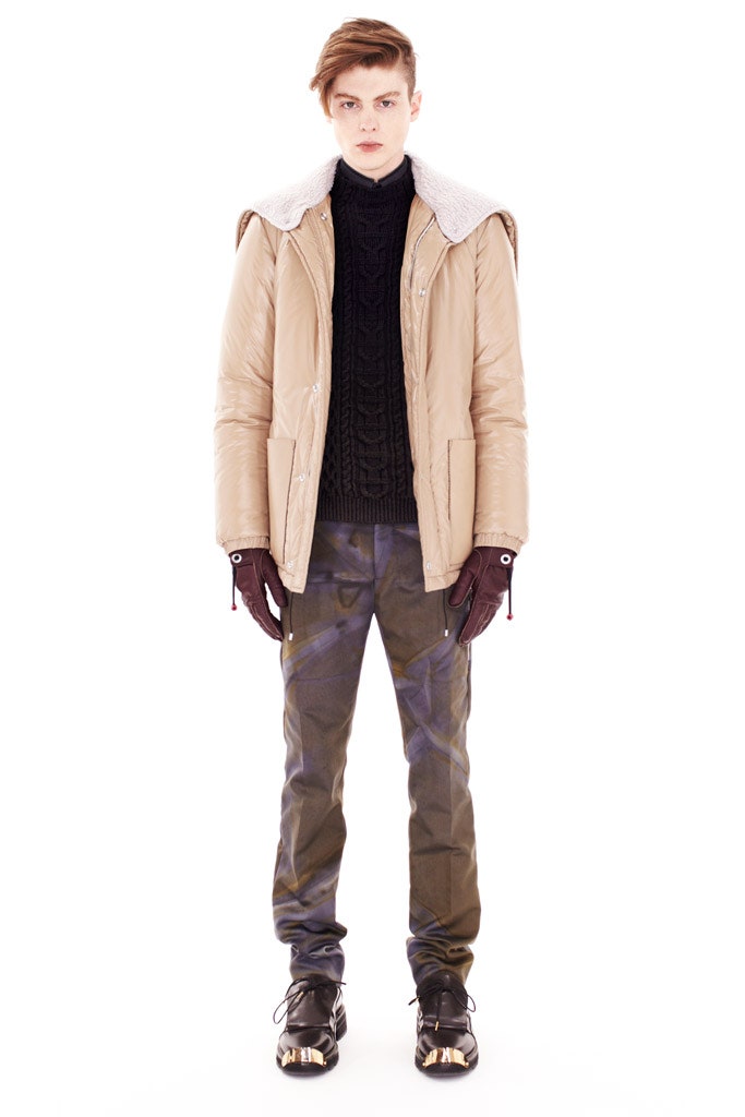beige jacket black sweater green pants