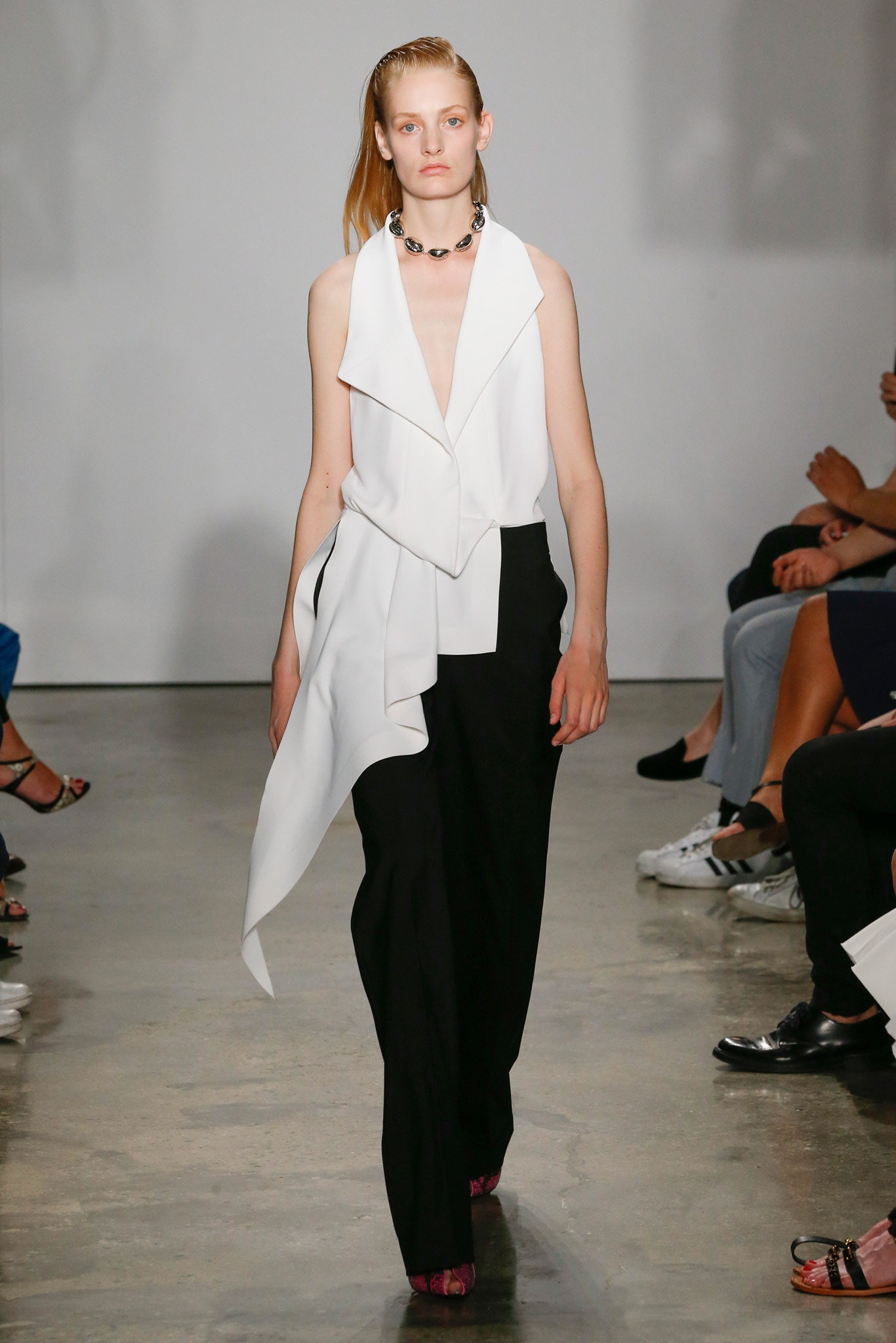 white silk sleeveless top with black pants