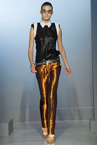 black silk sleeveless top and orange vinyl pants
