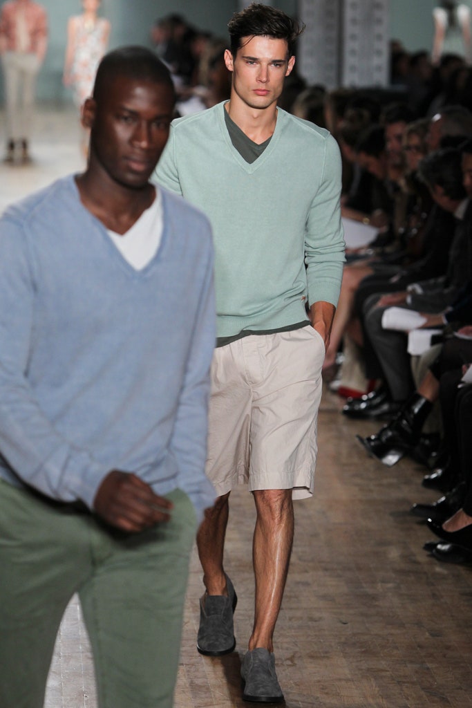 green relaxed sweater with beige shorts