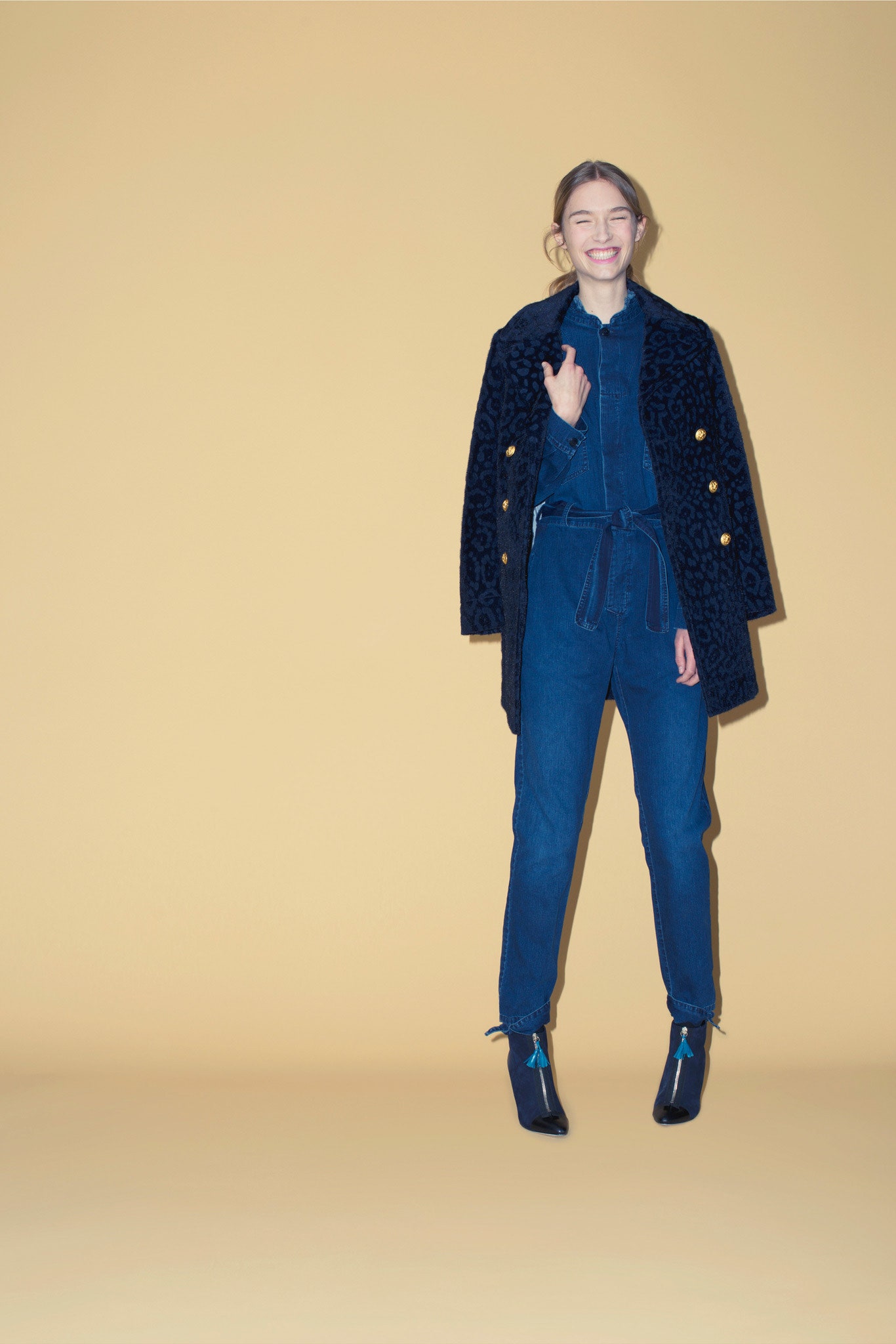 black faux-fur coat with denim jumpsuit