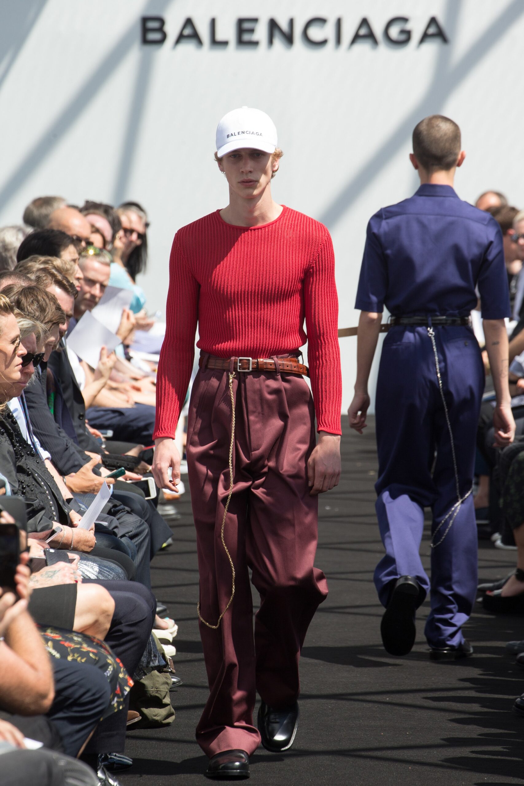 red fitted top with brown pants