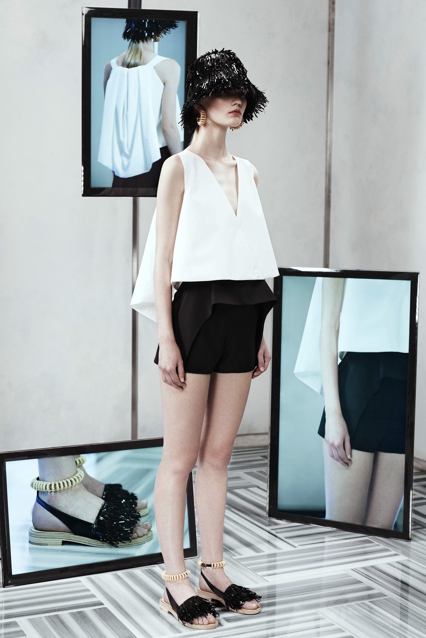 white relaxed top with black shorts