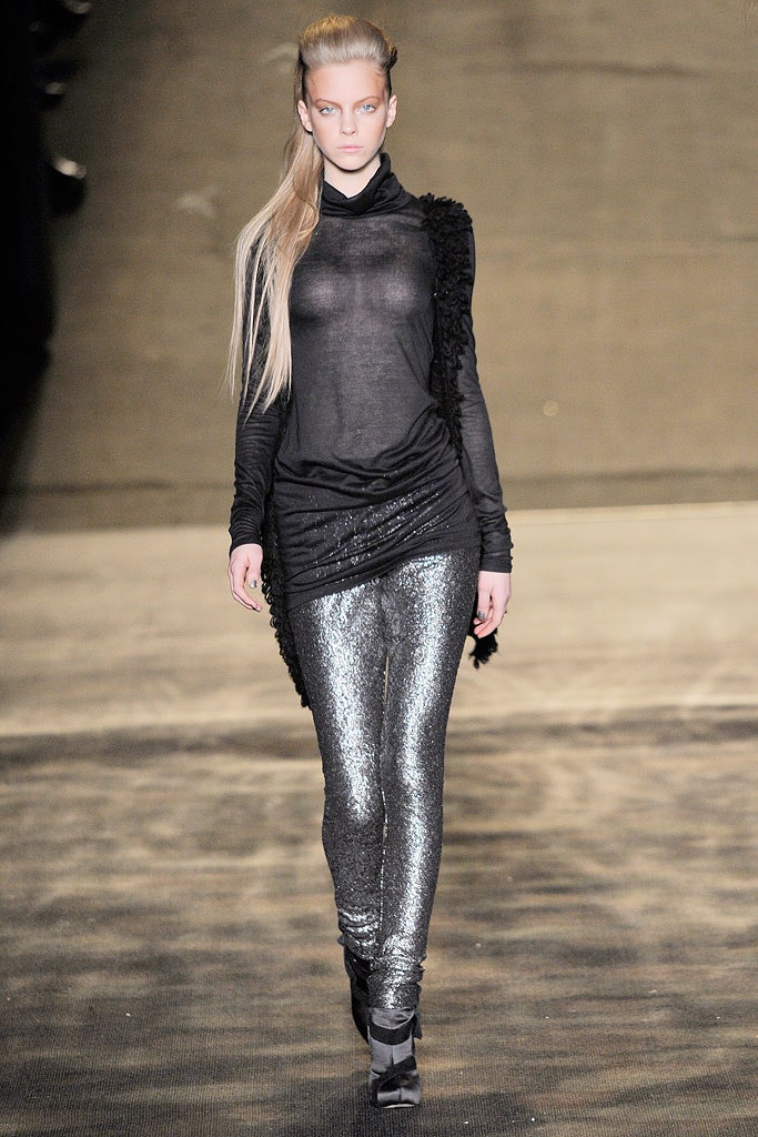 black sheer turtleneck top with silver pants