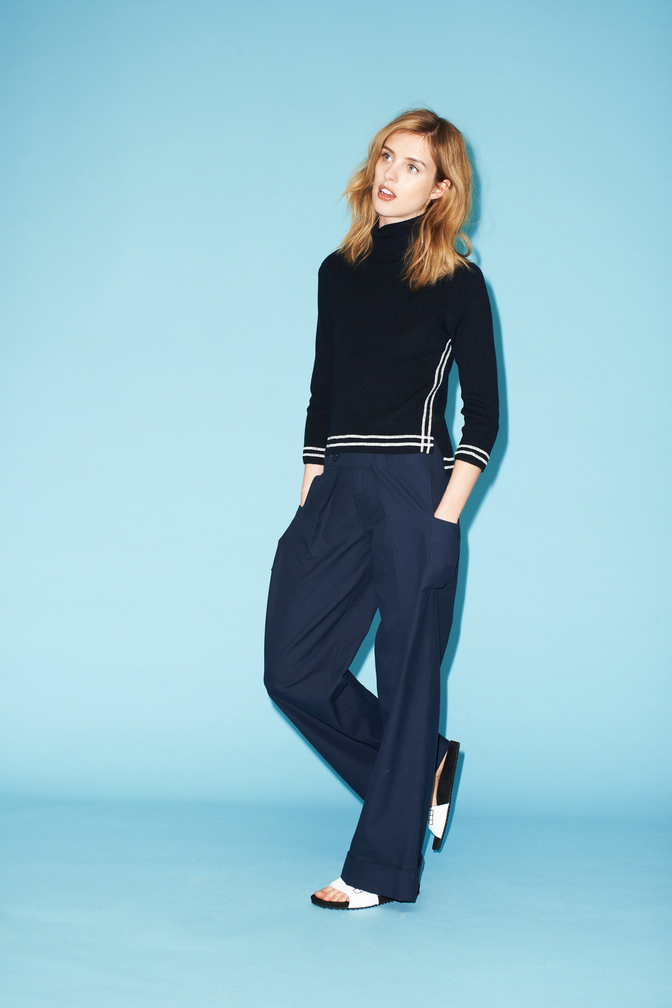 black fitted sweater with navy pants