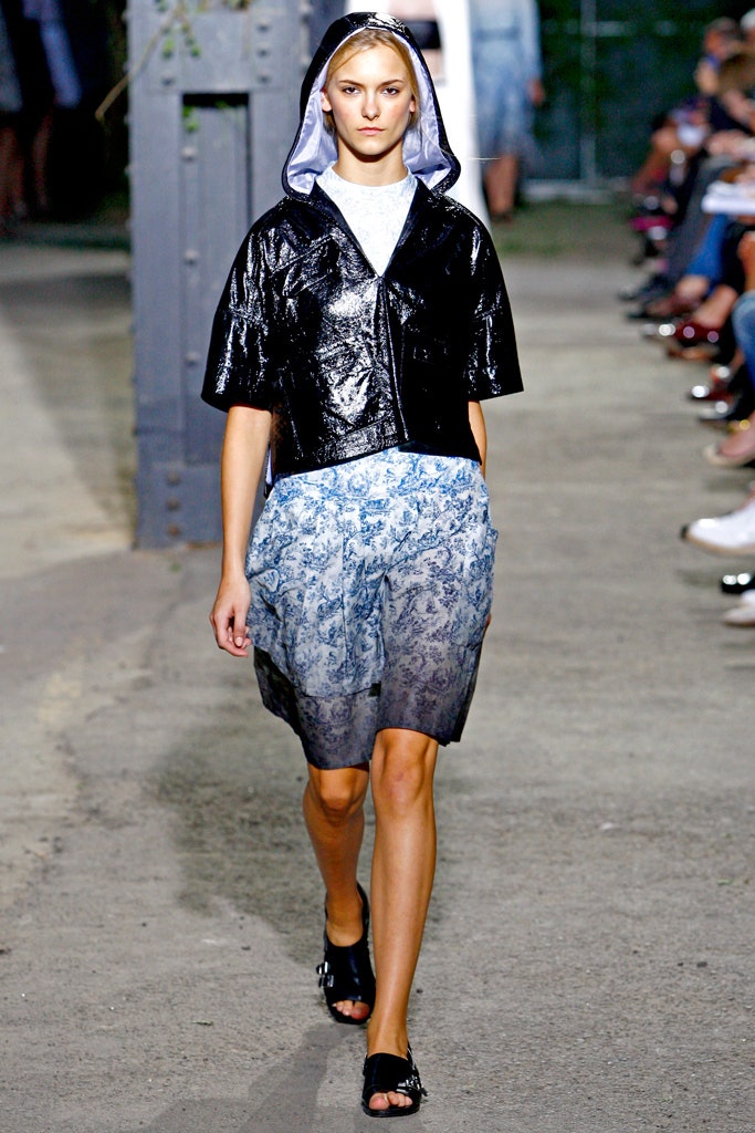 black vinyl hooded jacket and blue printed shorts