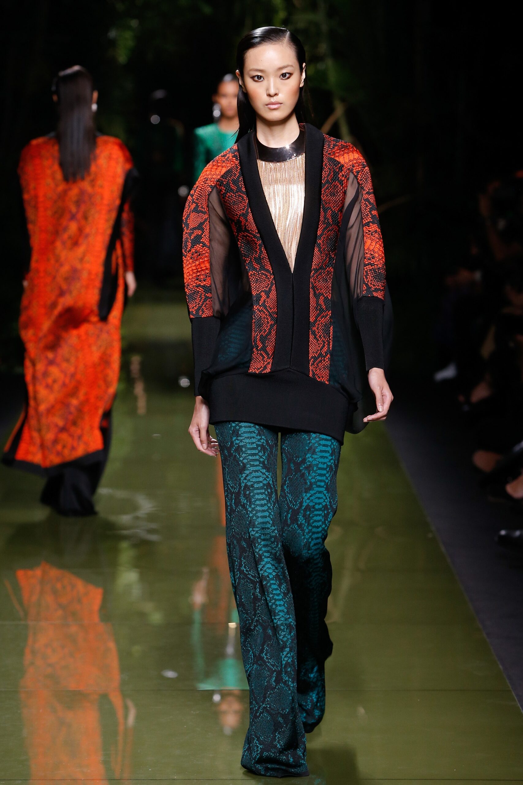 fitted black and red layered top with teal flared pants