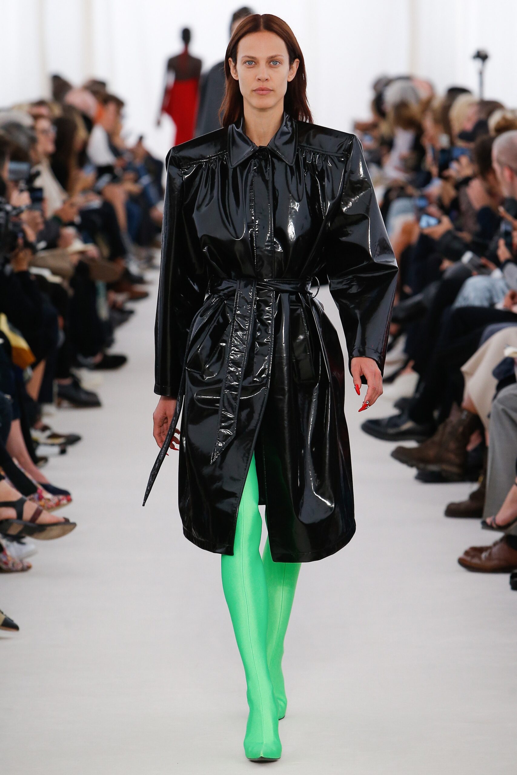 black vinyl belted coat with green shoes