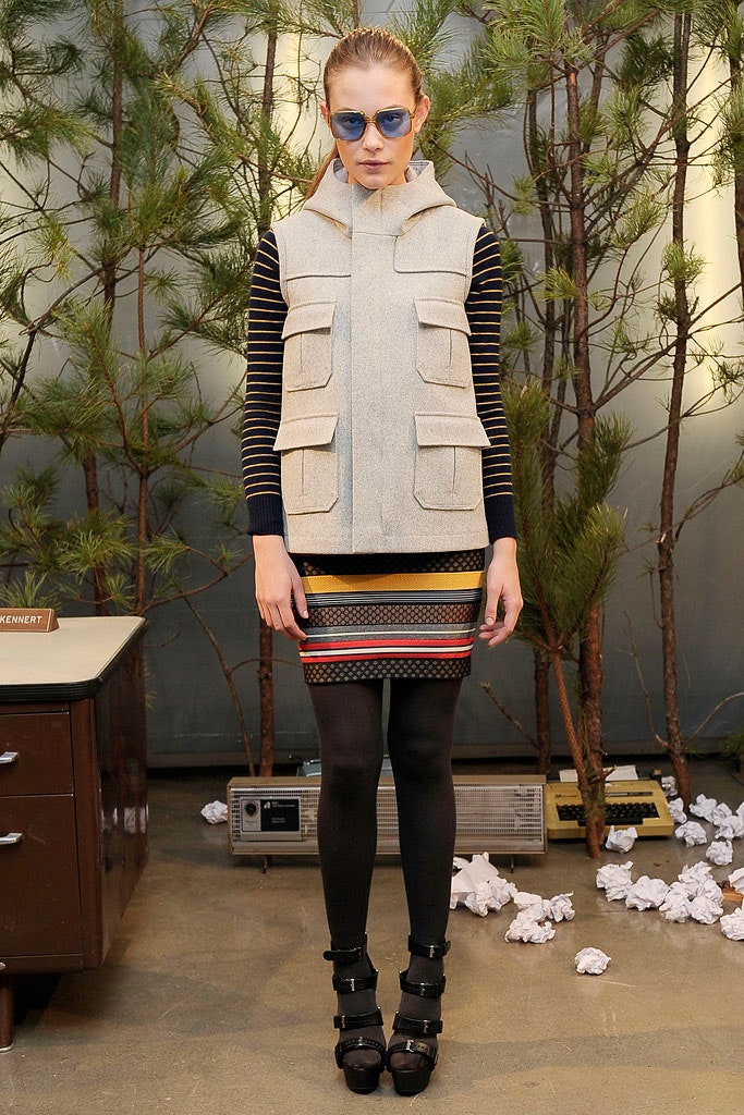 beige hooded vest with striped top and mini skirt