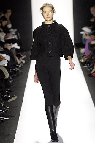 black fitted jacket with leggings and boots