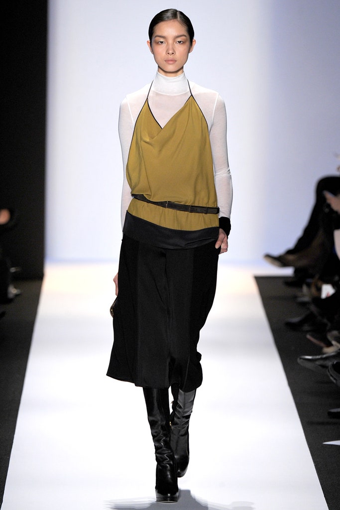 layered green and black top with wide-leg pants