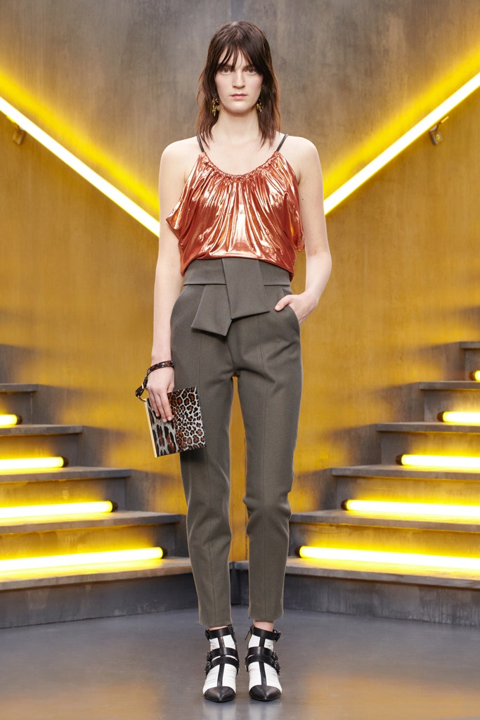 shiny orange sleeveless top with tailored pants