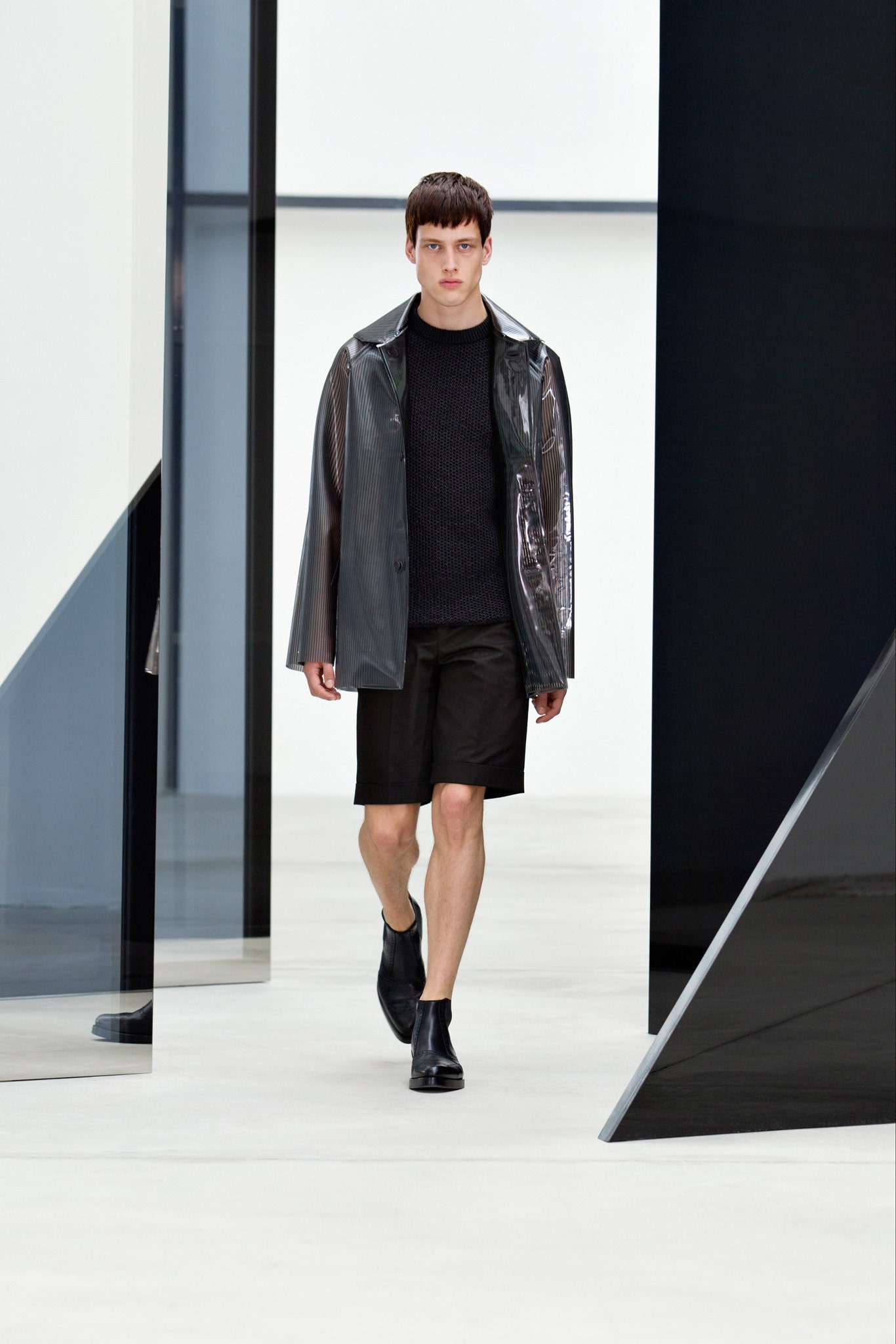 black vinyl jacket with sweater and shorts