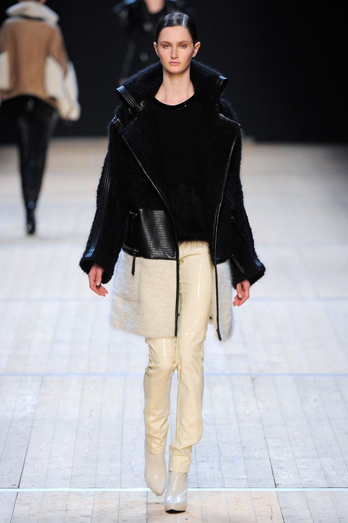 black and white fitted coat with beige pants