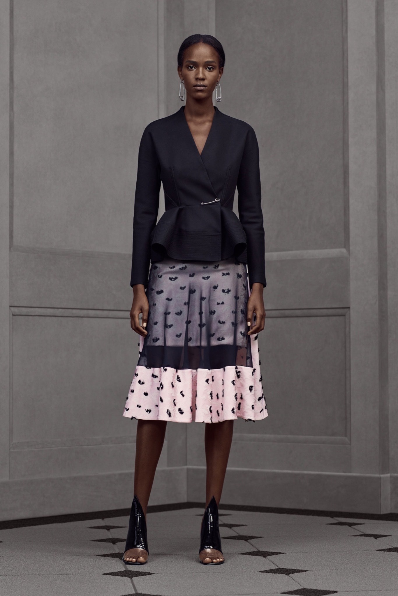 black fitted blazer with pleated skirt