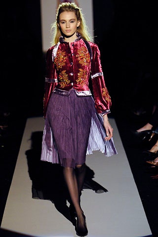 red velvet blouse with embroidered details and purple pleated skirt