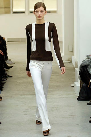 brown and white fitted top with white pants