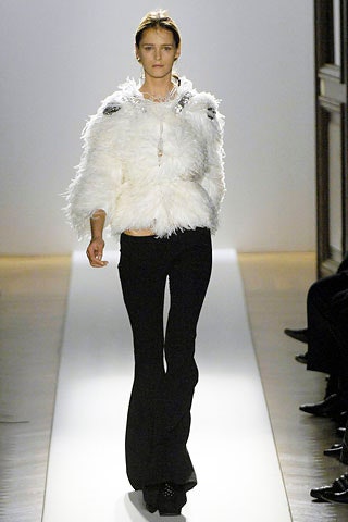 white fur jacket and black flared pants