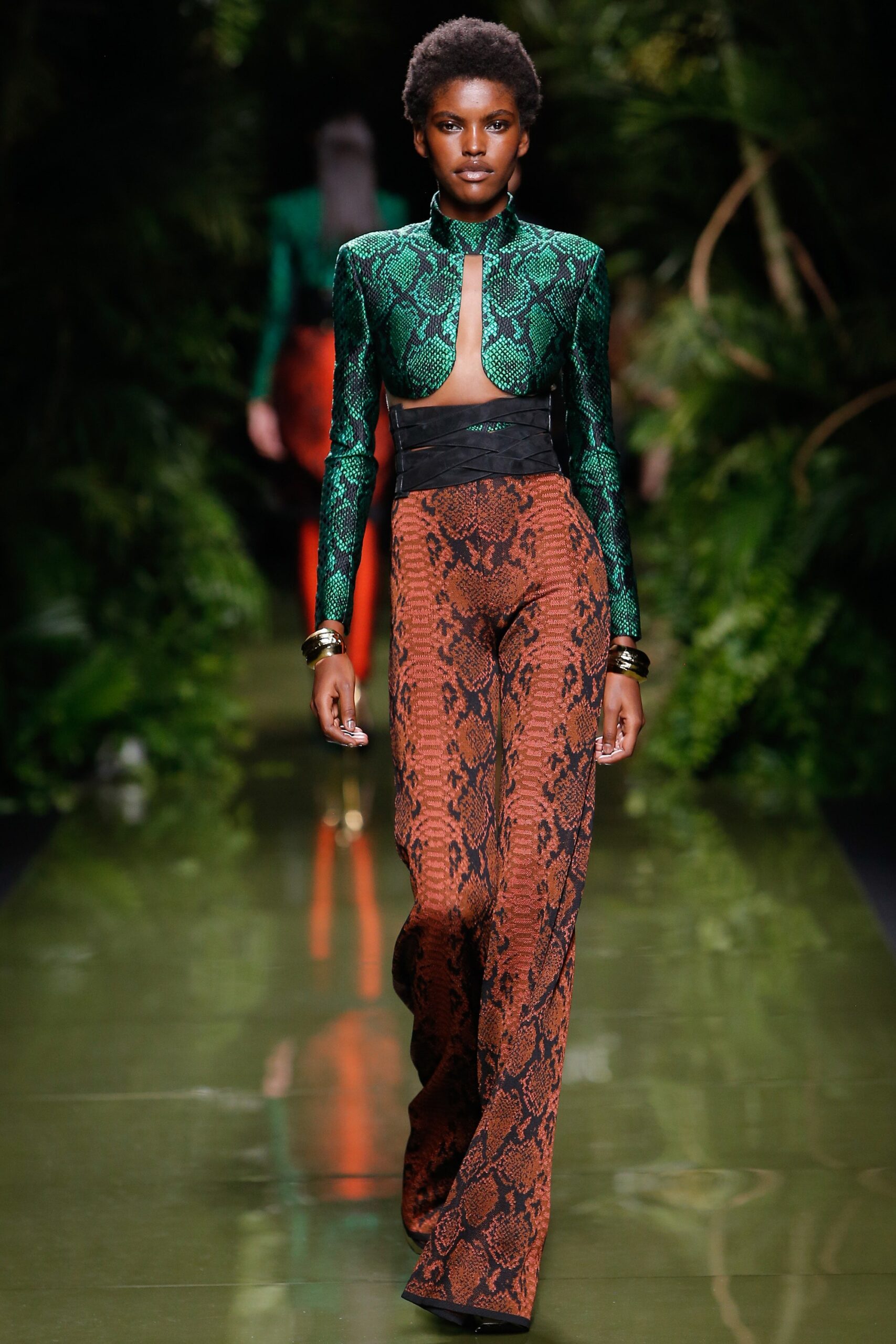 fitted green silk top and orange pants
