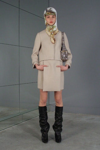 beige fitted coat with black boots