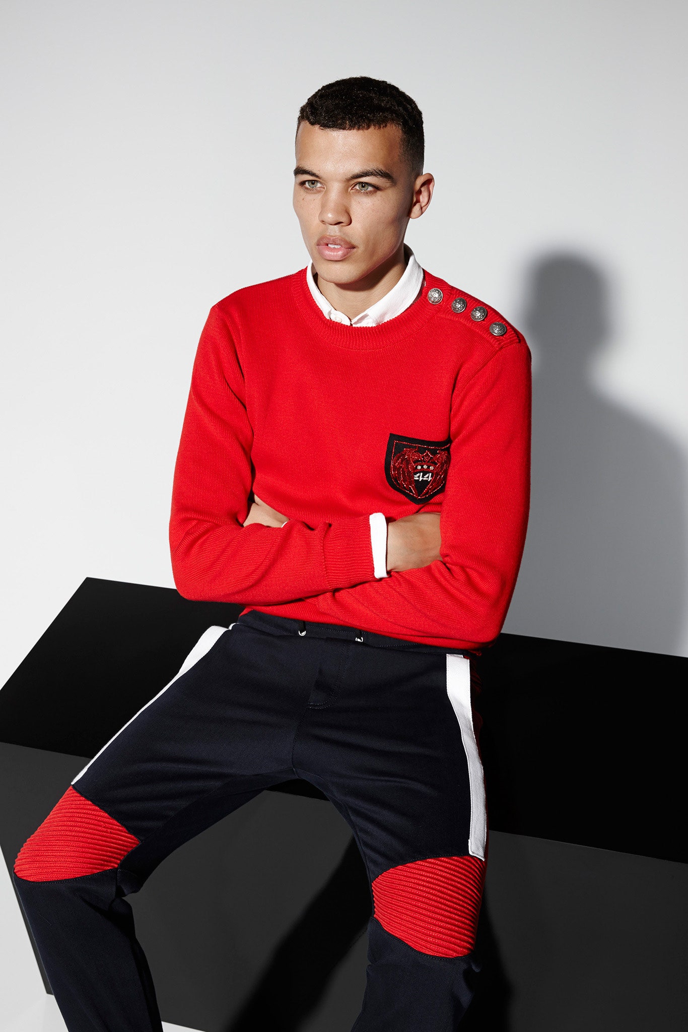 red fitted sweater and navy pants