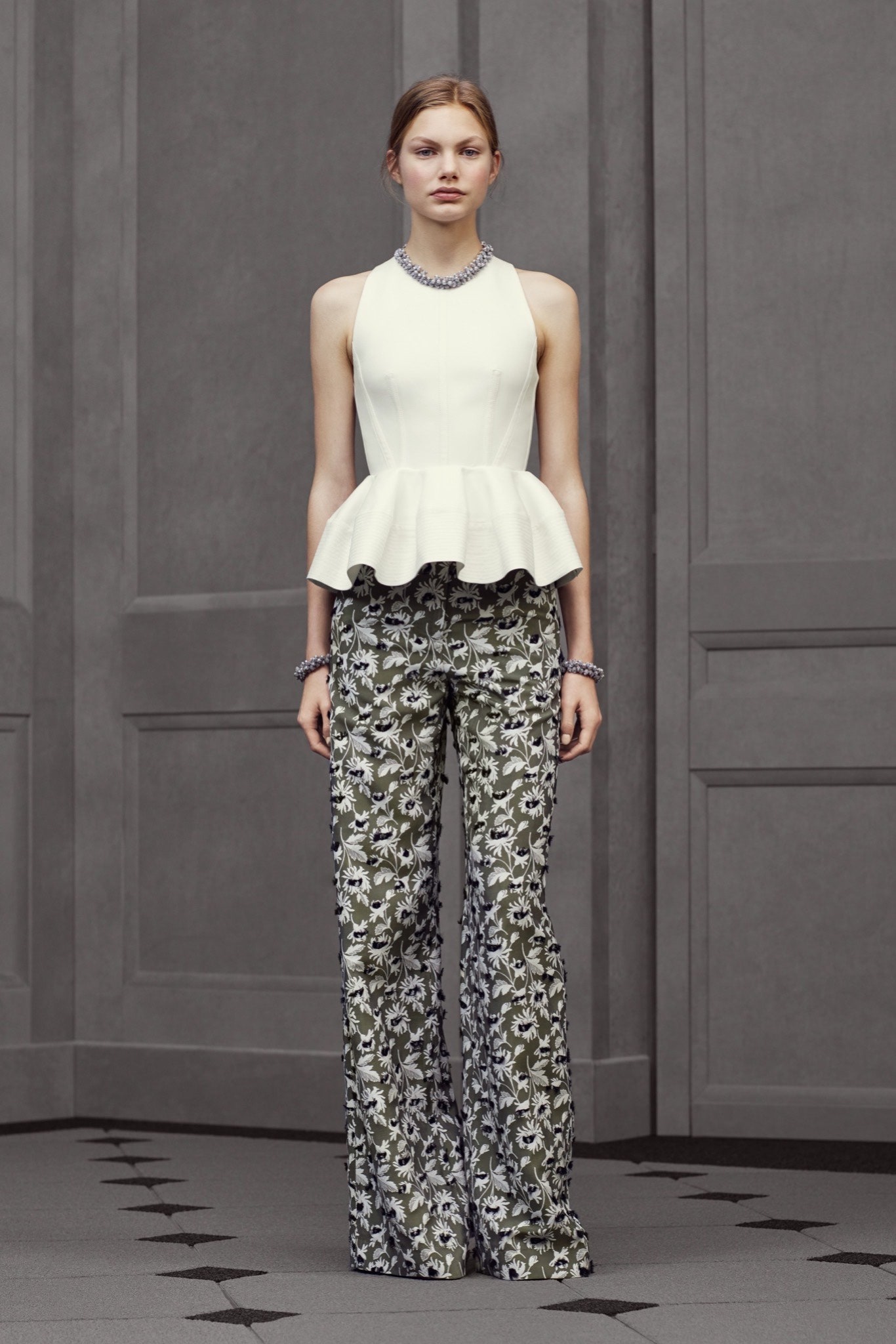 white fitted peplum top and green flared pants