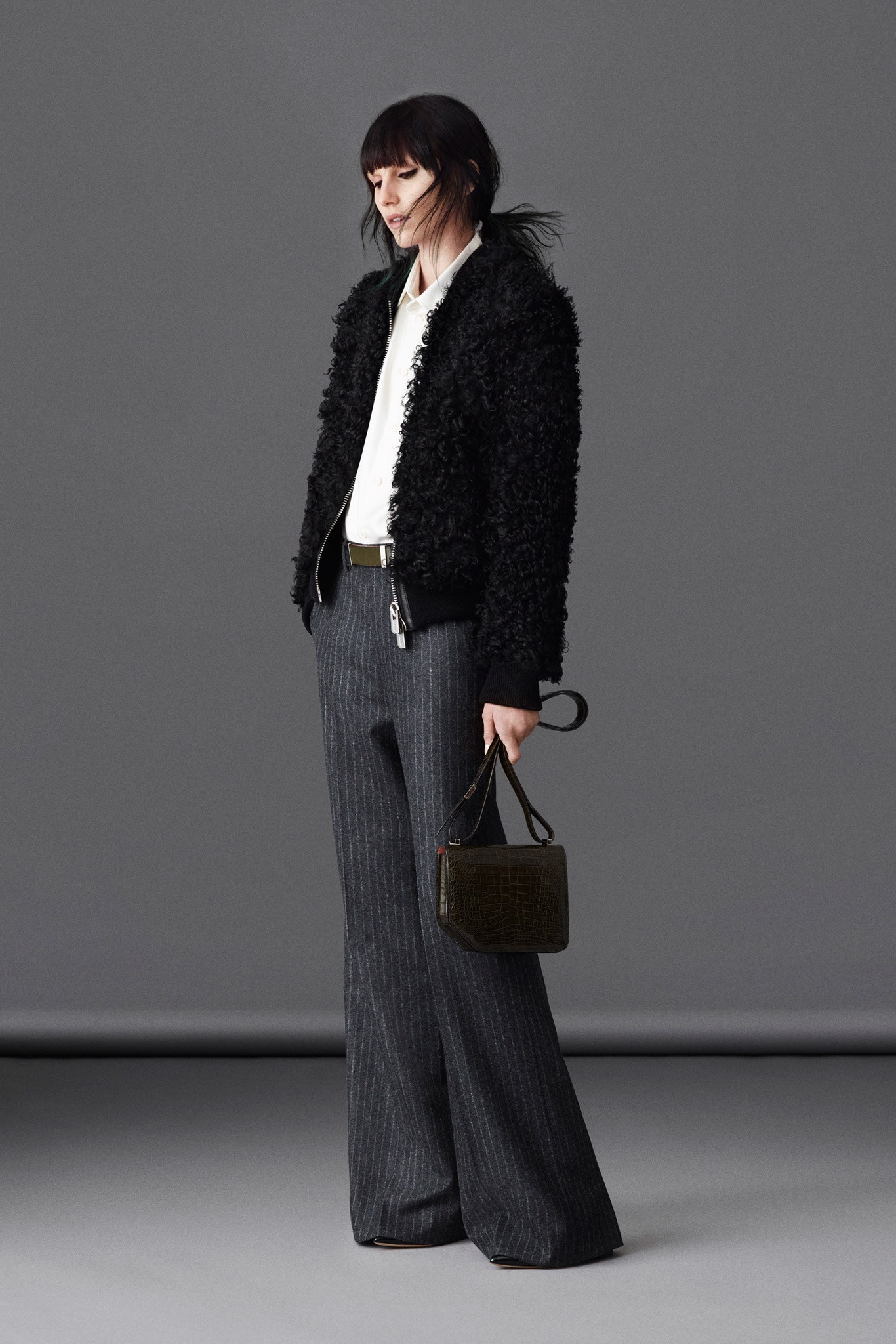 black faux-fur jacket with gray pants
