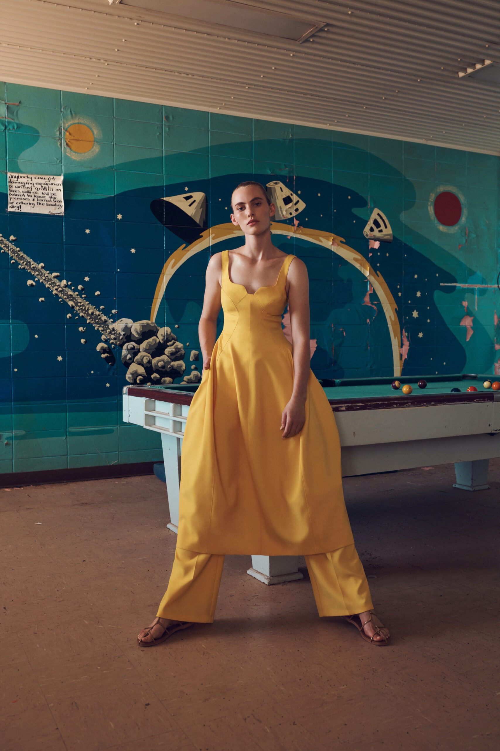 yellow square-neck dress over trousers
