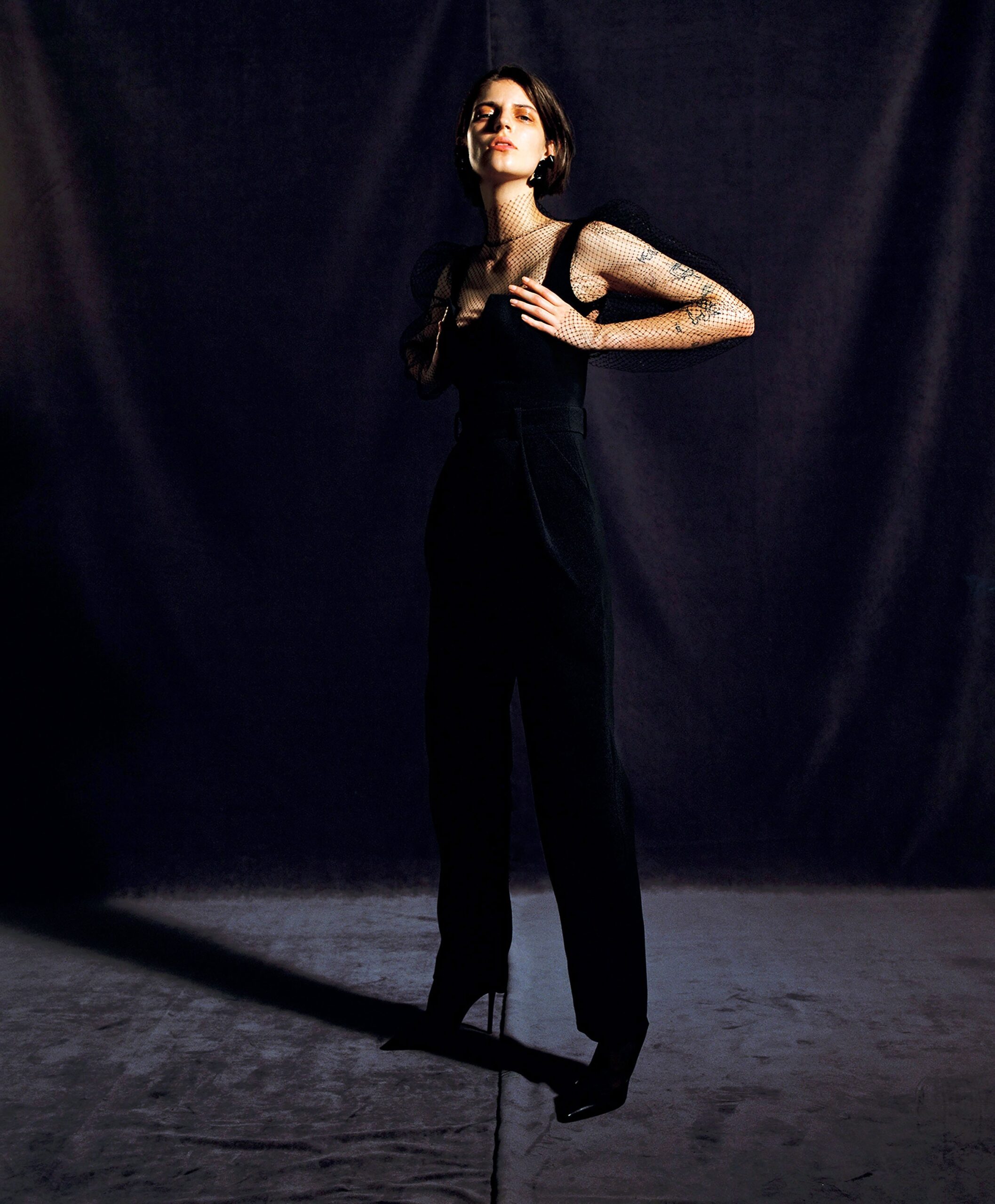 sheer fishnet top over black jumpsuit