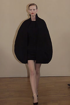 black cocoon coat over mini dress