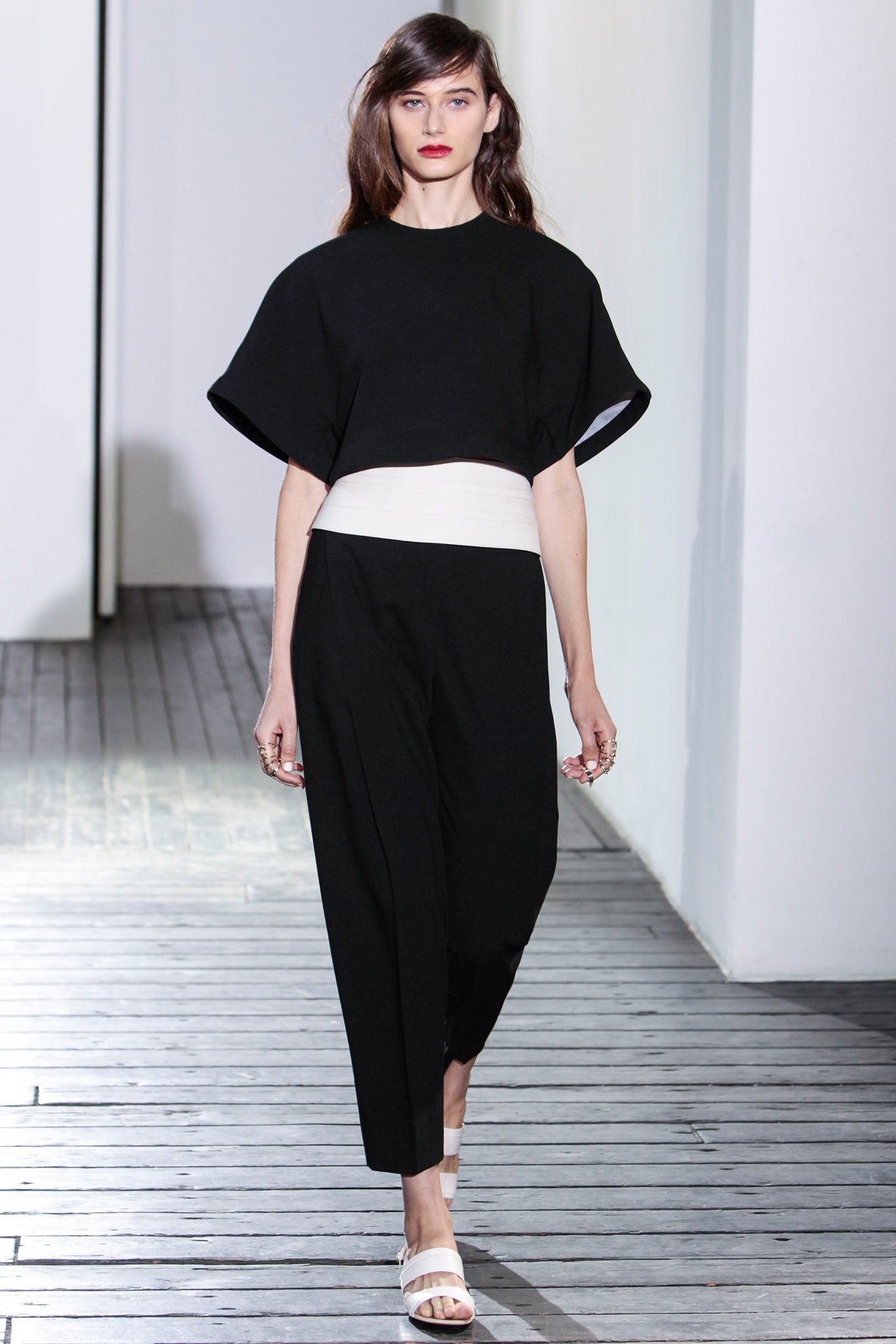black cropped top with wide white belt