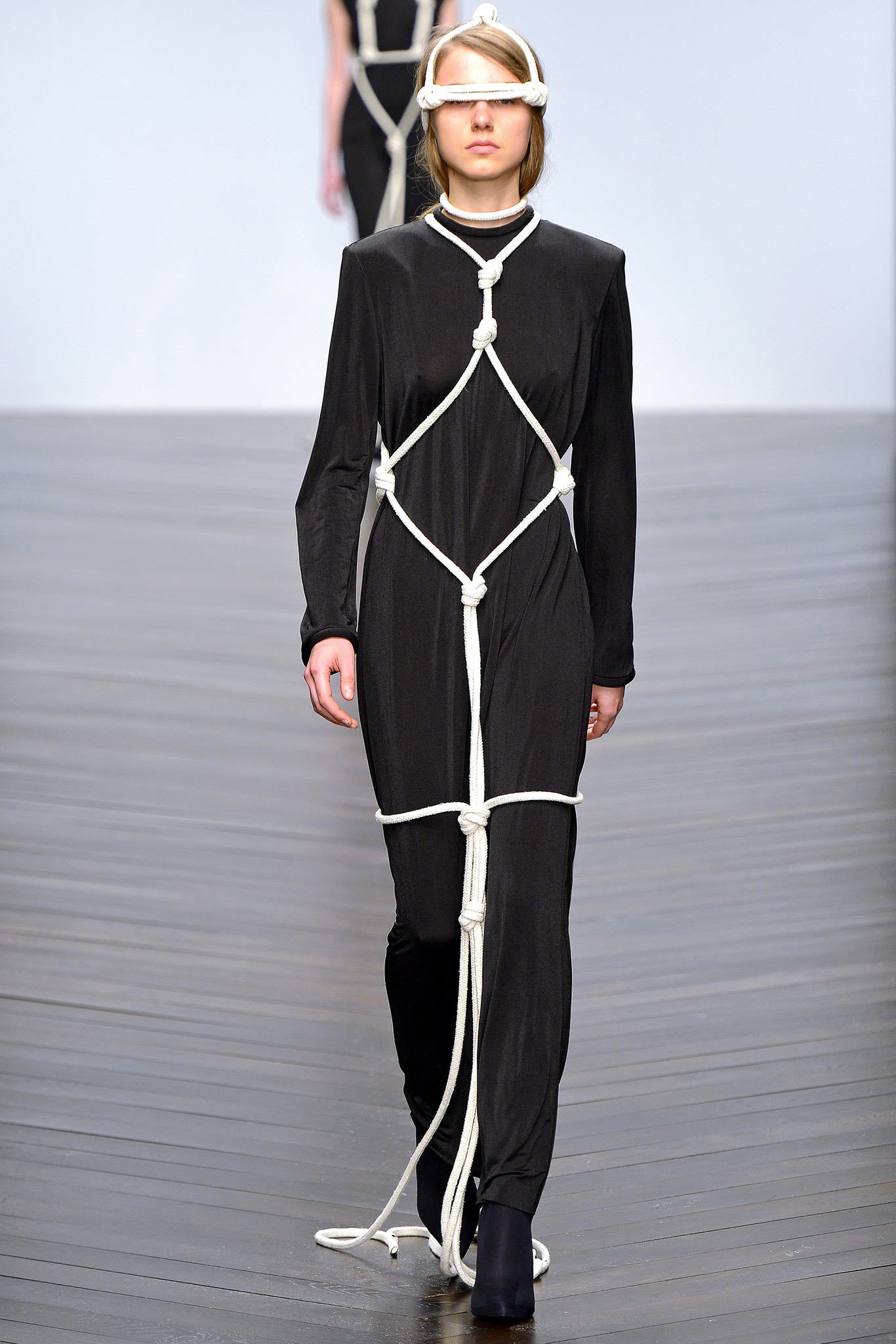 black draped jumpsuit with rope harness
