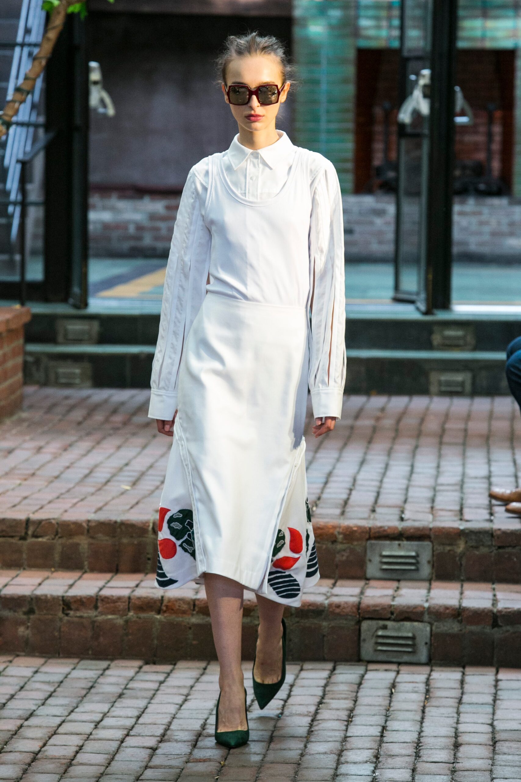 white layered apron dress over shirt