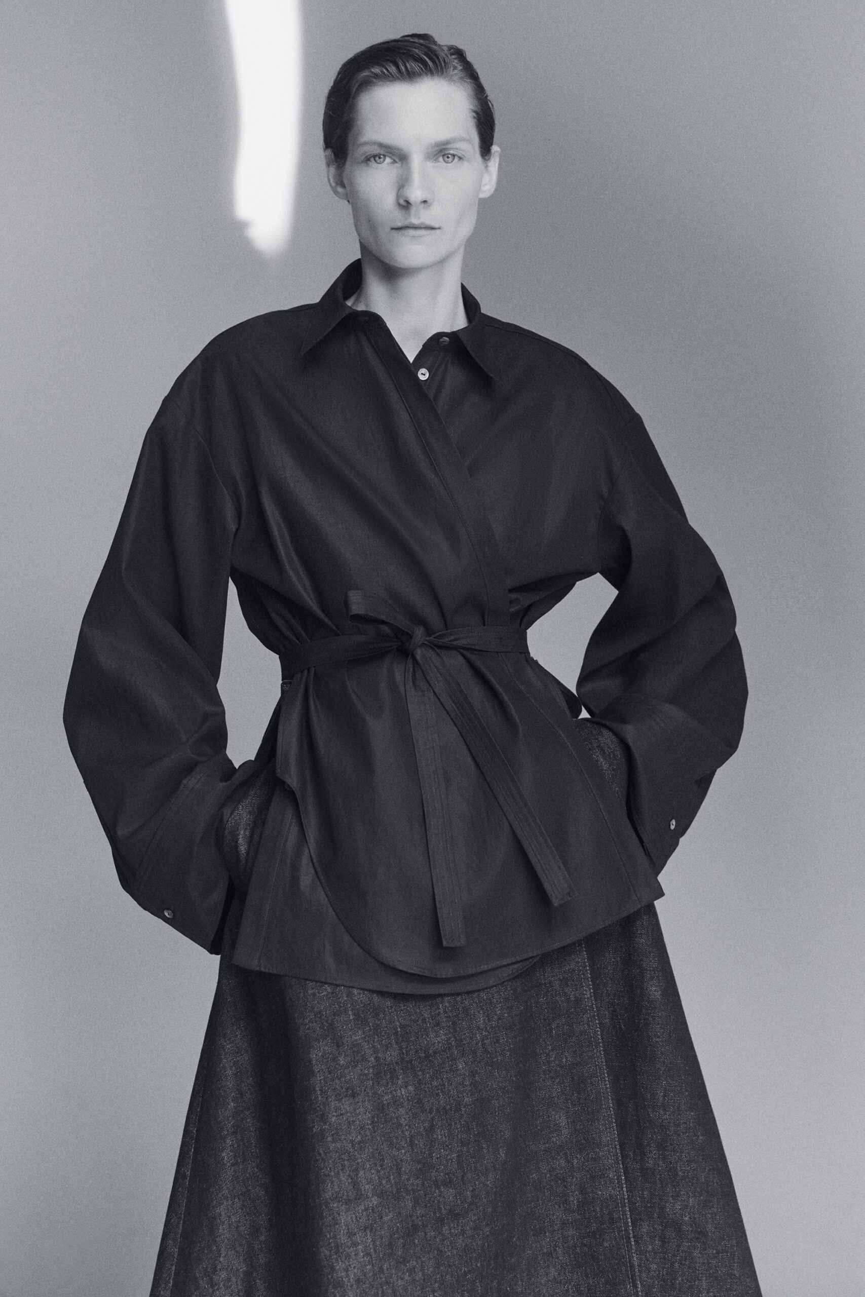black cotton long-sleeve collared oversized buttoned belted blouse
