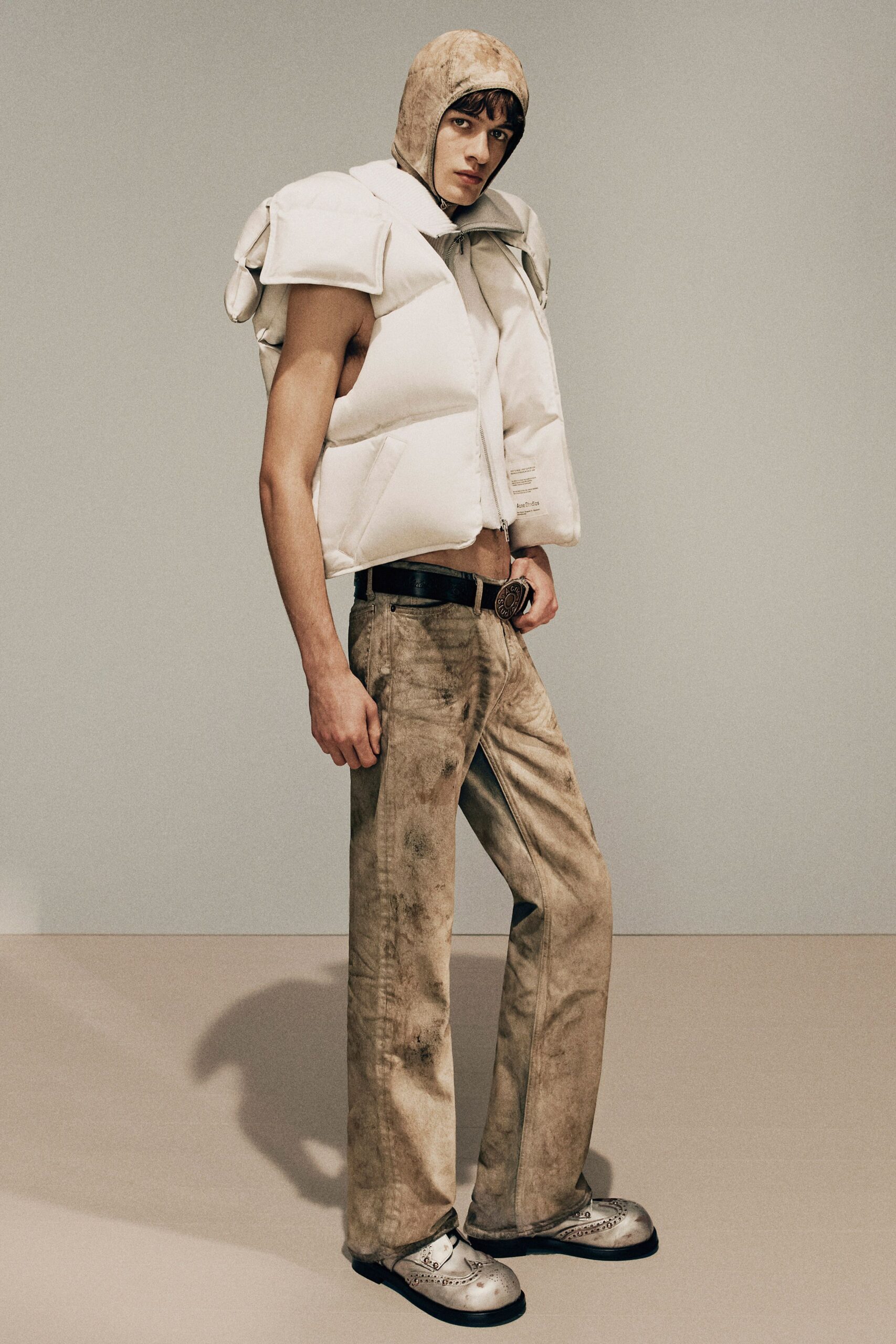 white padded vest beige pants