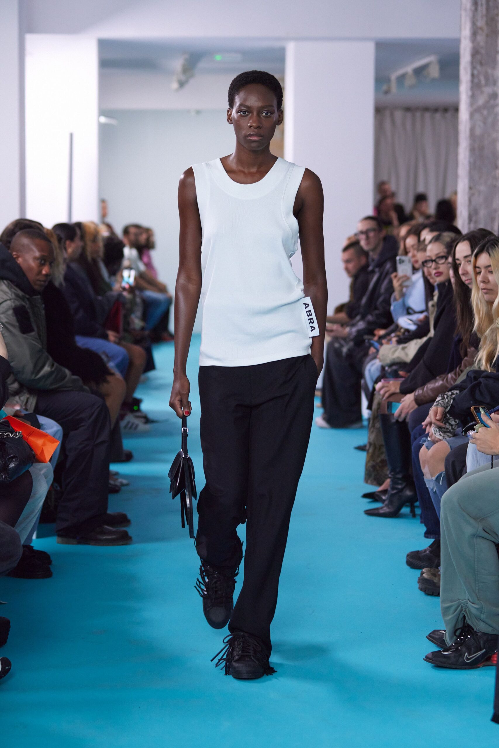 white fitted top black relaxed pants