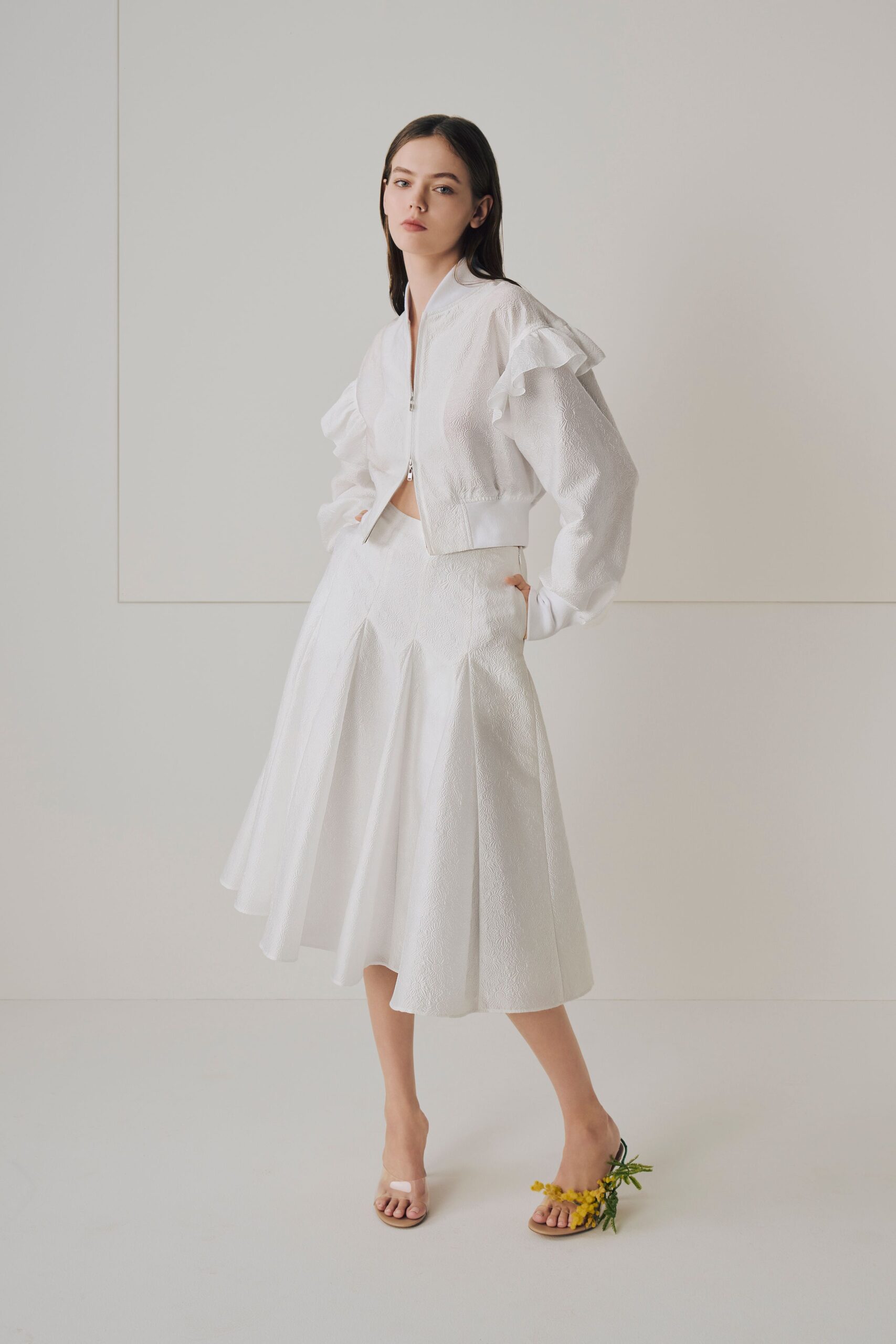 white ruffled jacket and flared skirt