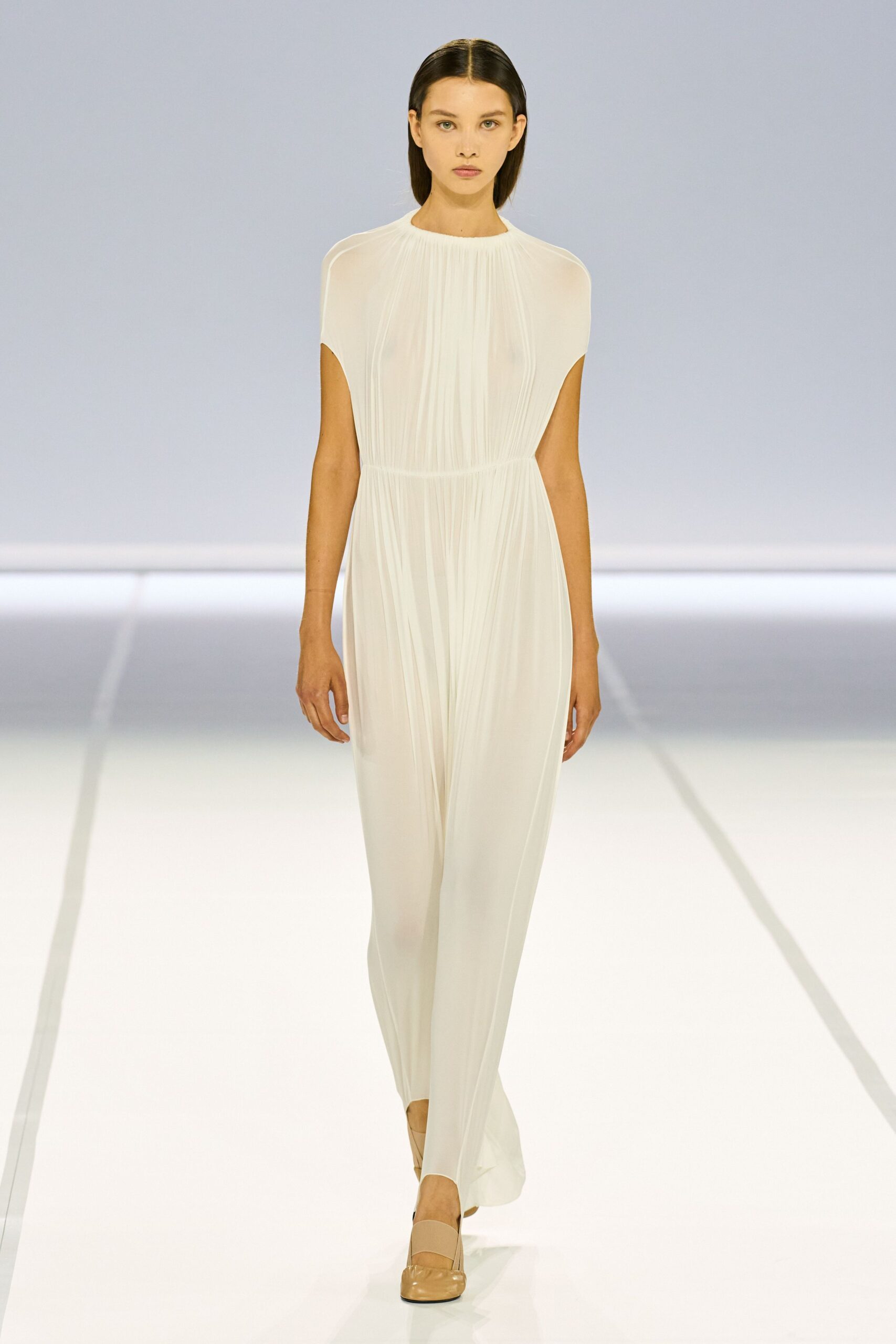 white pleated silk gown with beige shoes