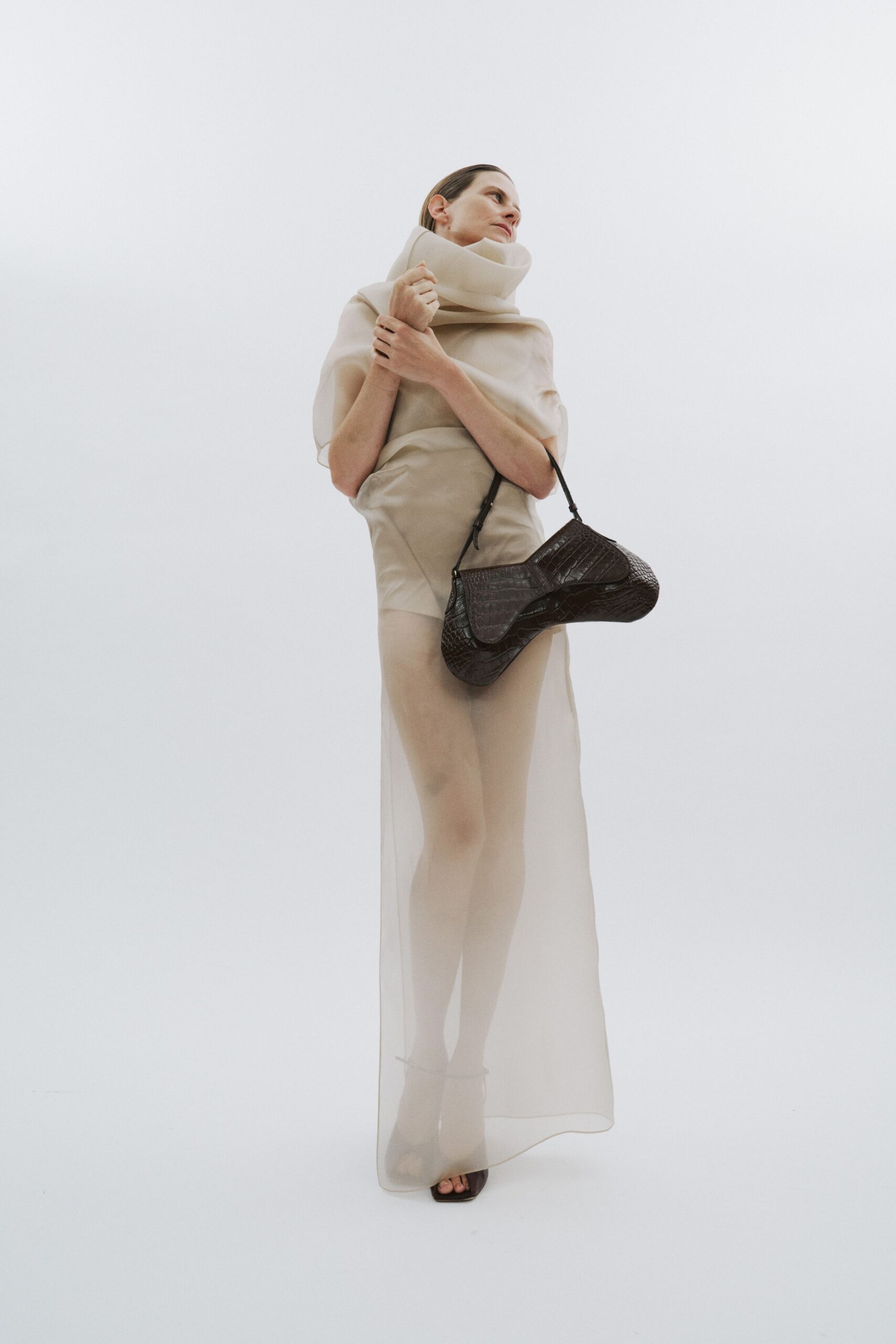 beige sheer maxi dress with black accessories
