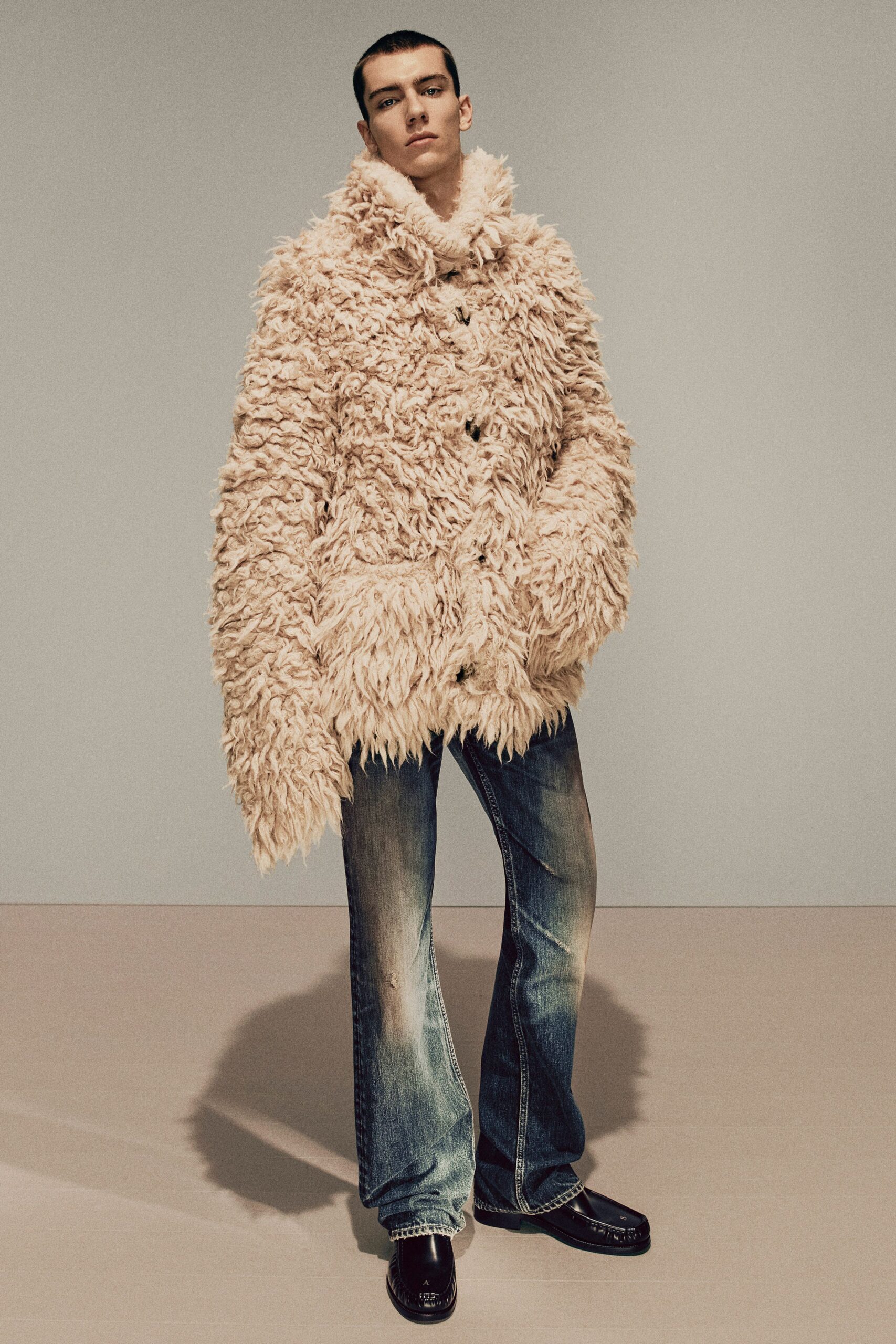 beige faux-fur coat with flared jeans