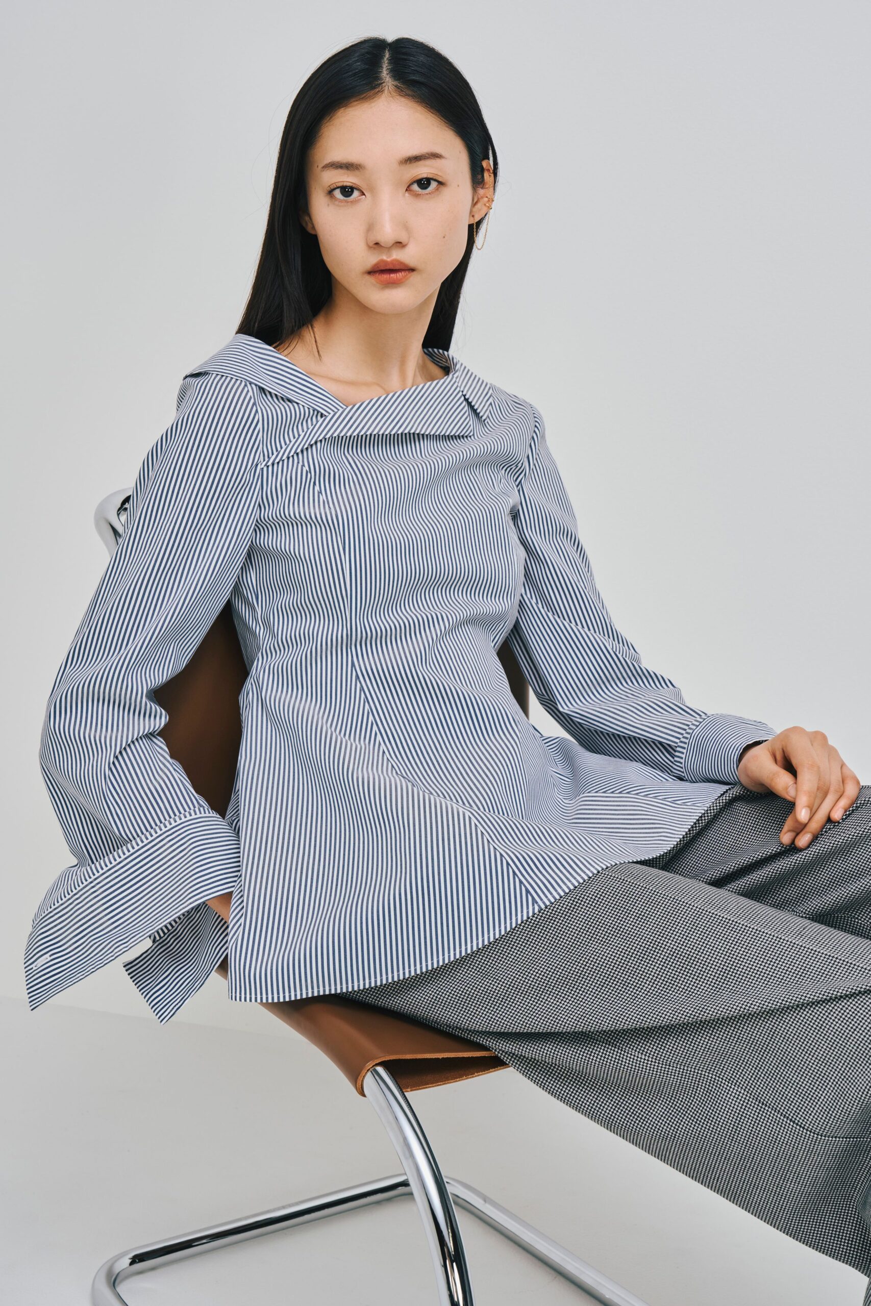 striped blue and white top with gray pants