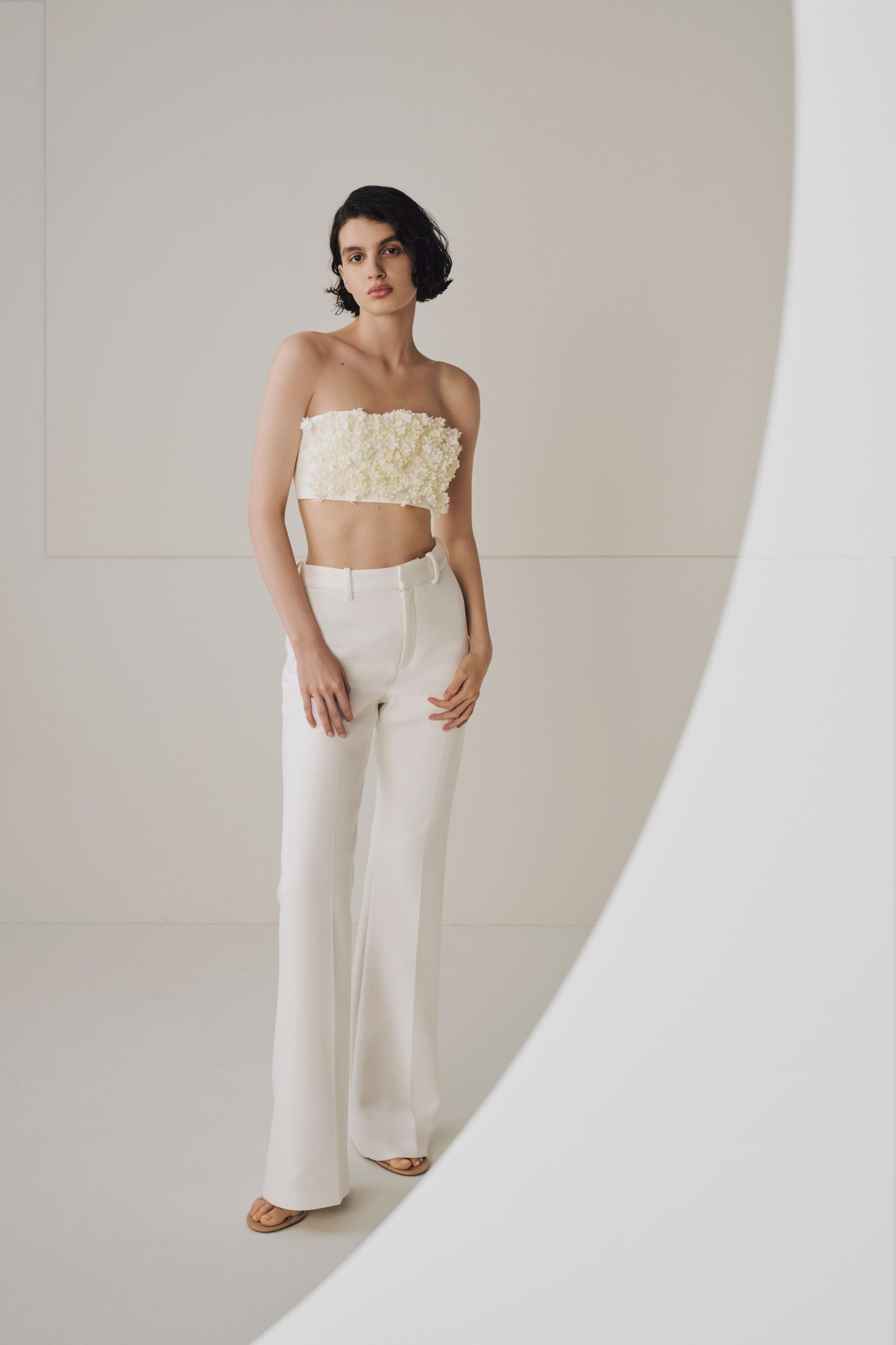 white embellished top with flared pants