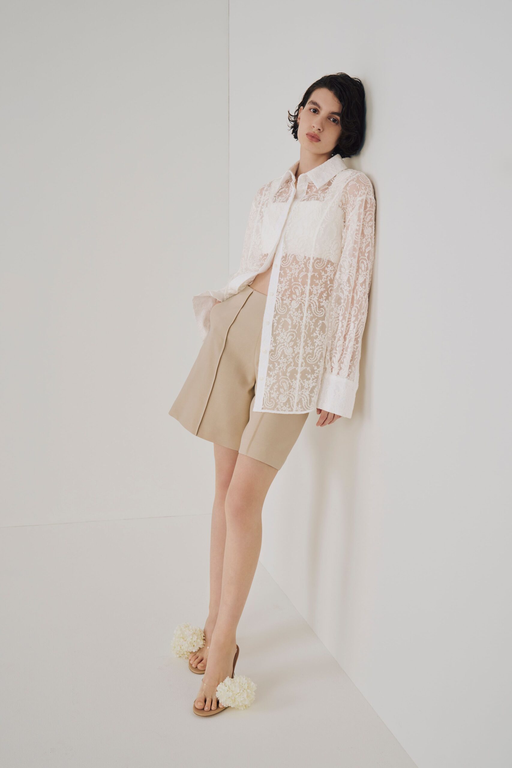 white lace shirt beige shorts