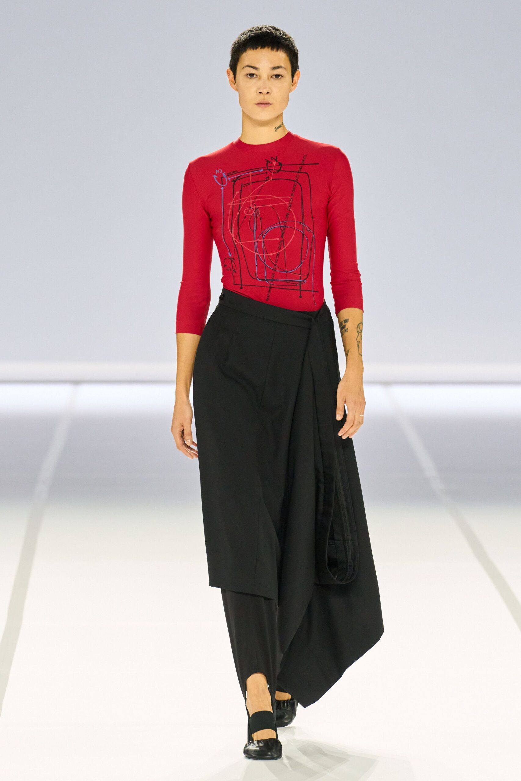 red fitted top with black skirt