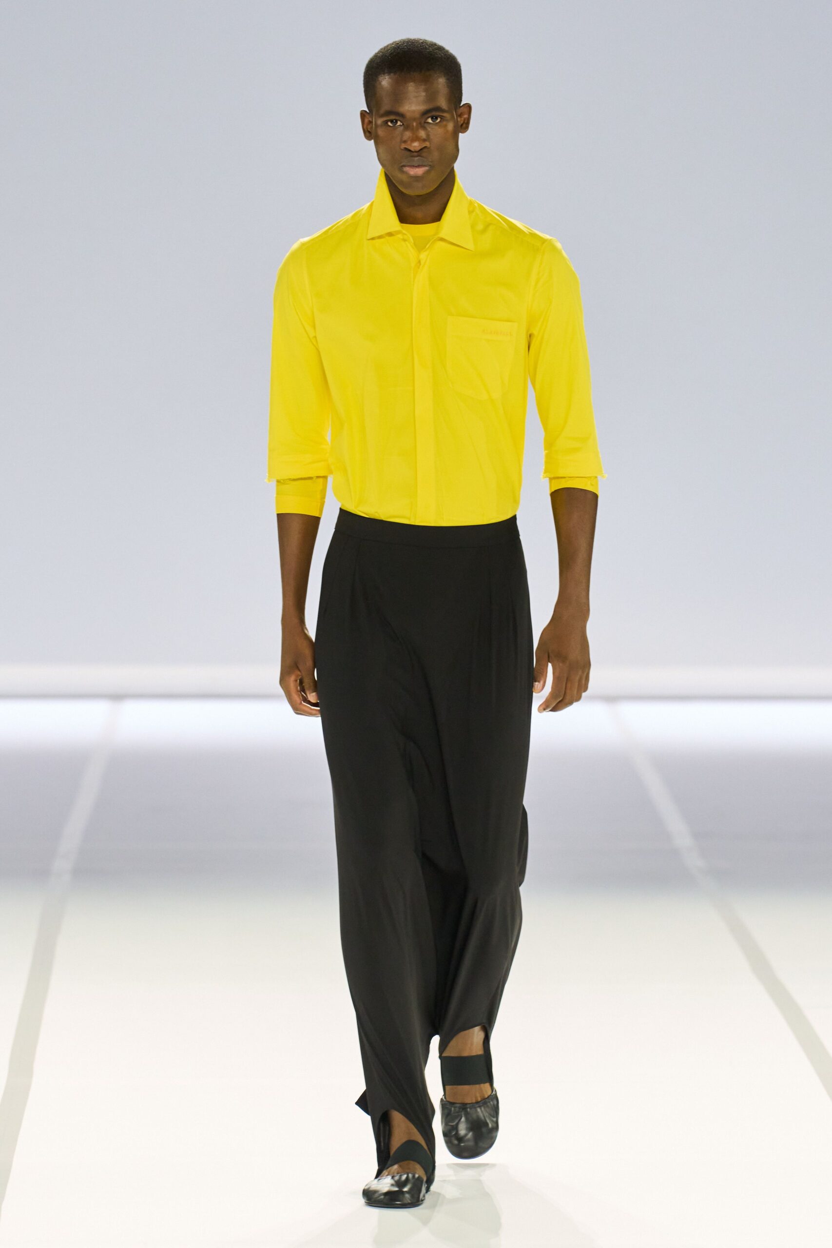 yellow shirt black wide-leg pants