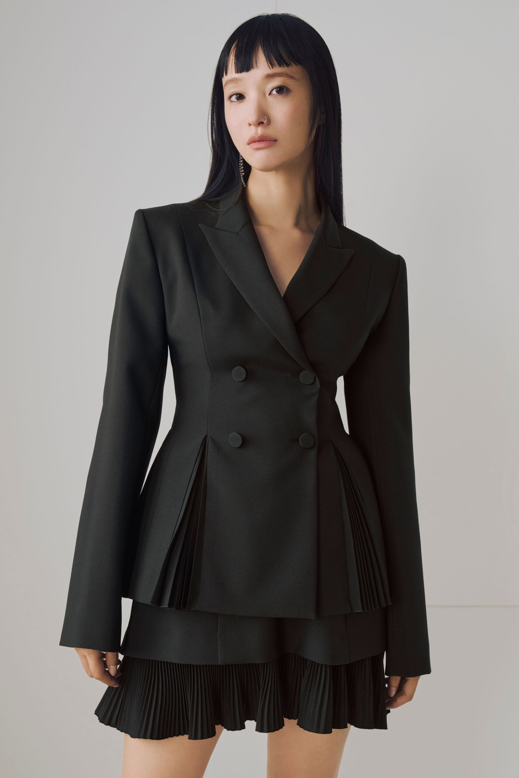 black structured blazer with pleated skirt