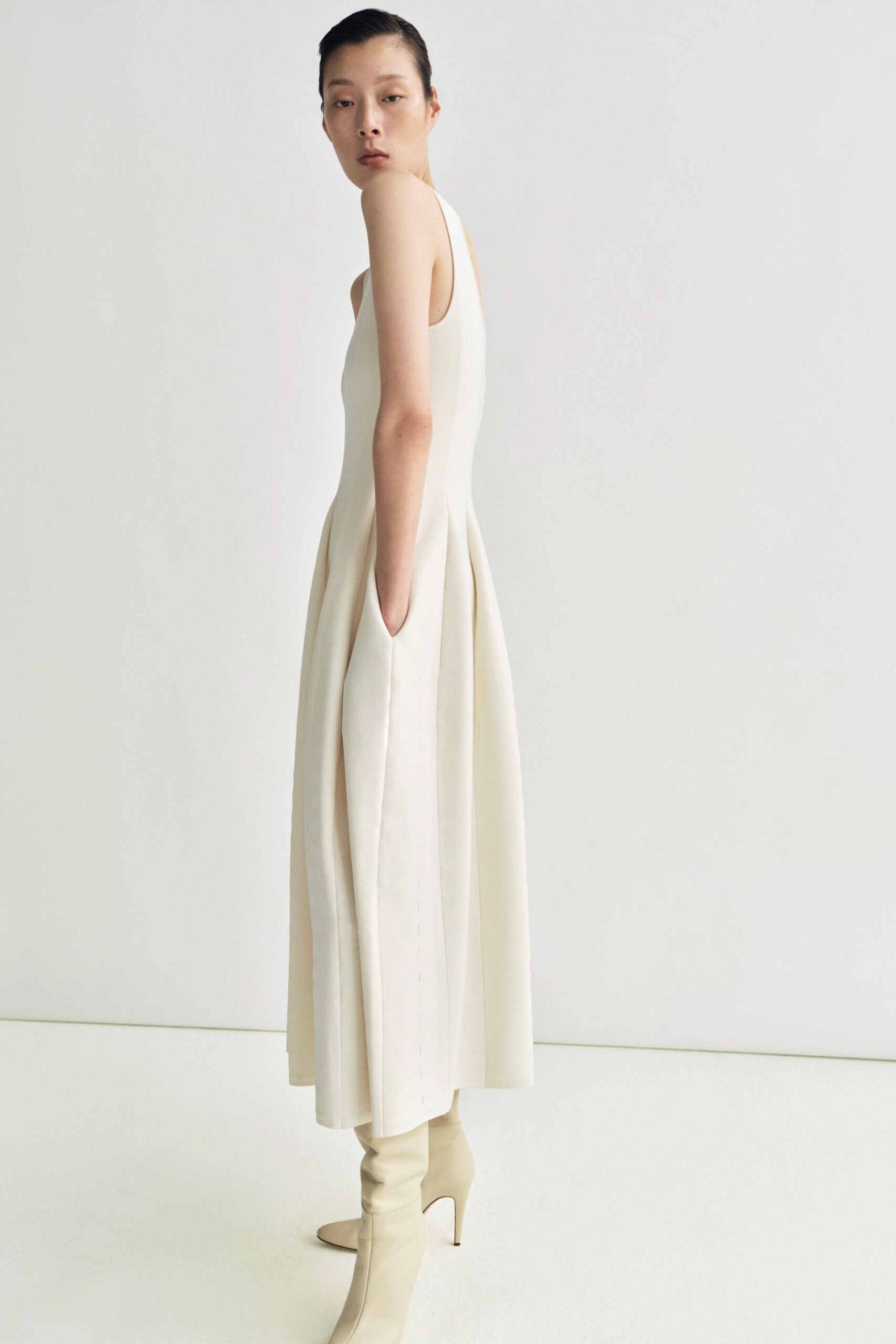 white pleated midi dress with beige boots